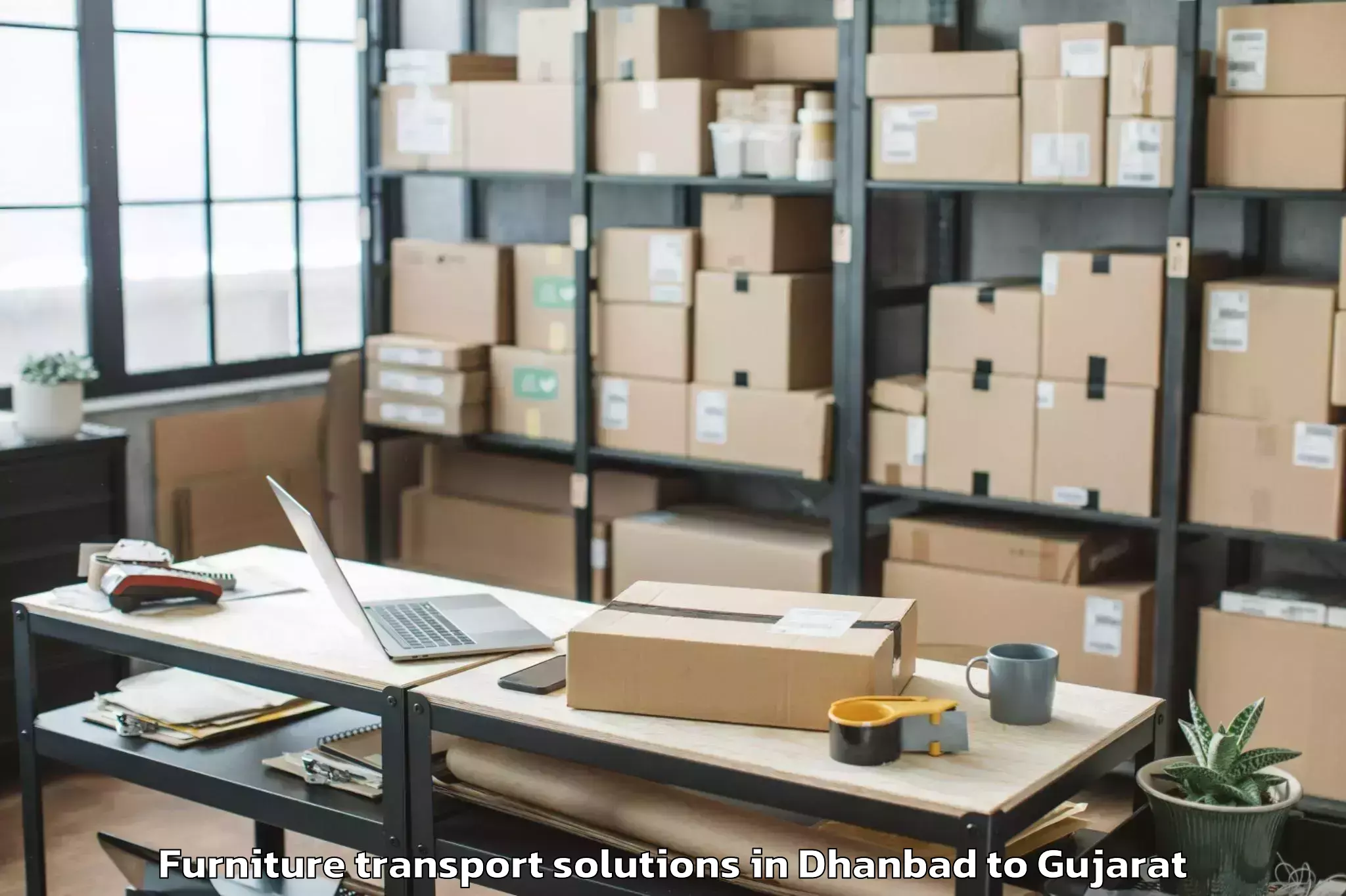 Book Dhanbad to Gussar Furniture Transport Solutions